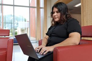 Applications programming student Evelyn Zuniga studying on her laptop