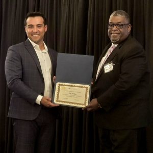 Ivy Jenkins accepting scholarship from Richard Shook