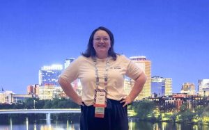 Stephanie Funderburg standing outside with a cityscape in the background