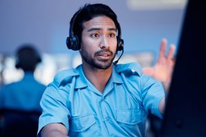 Emergency dispatcher with a headset talking to a caller