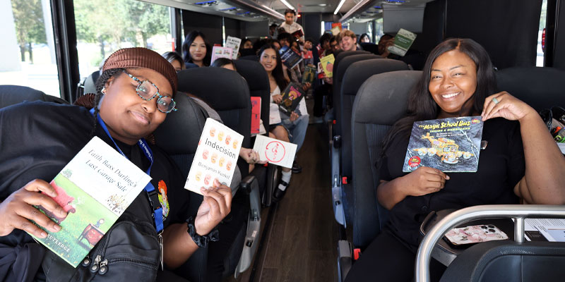 Professors and students on charter bus for Magic Book Bus literary field trip.