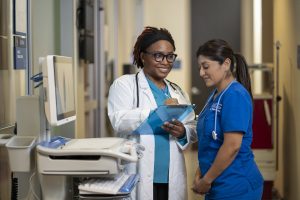 Two nurses working together at nurses' station