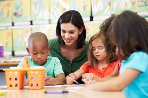 Teacher working with young children in classroom