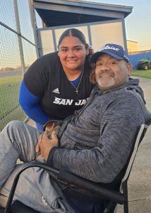 Ravens softball player Emily Garcia with her father